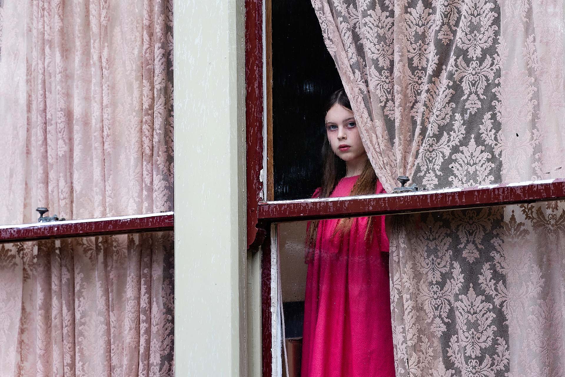 Reunion film still, girl looking out the window